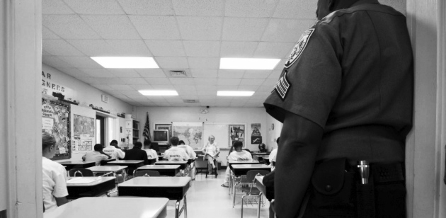A police officer leans into a classroom