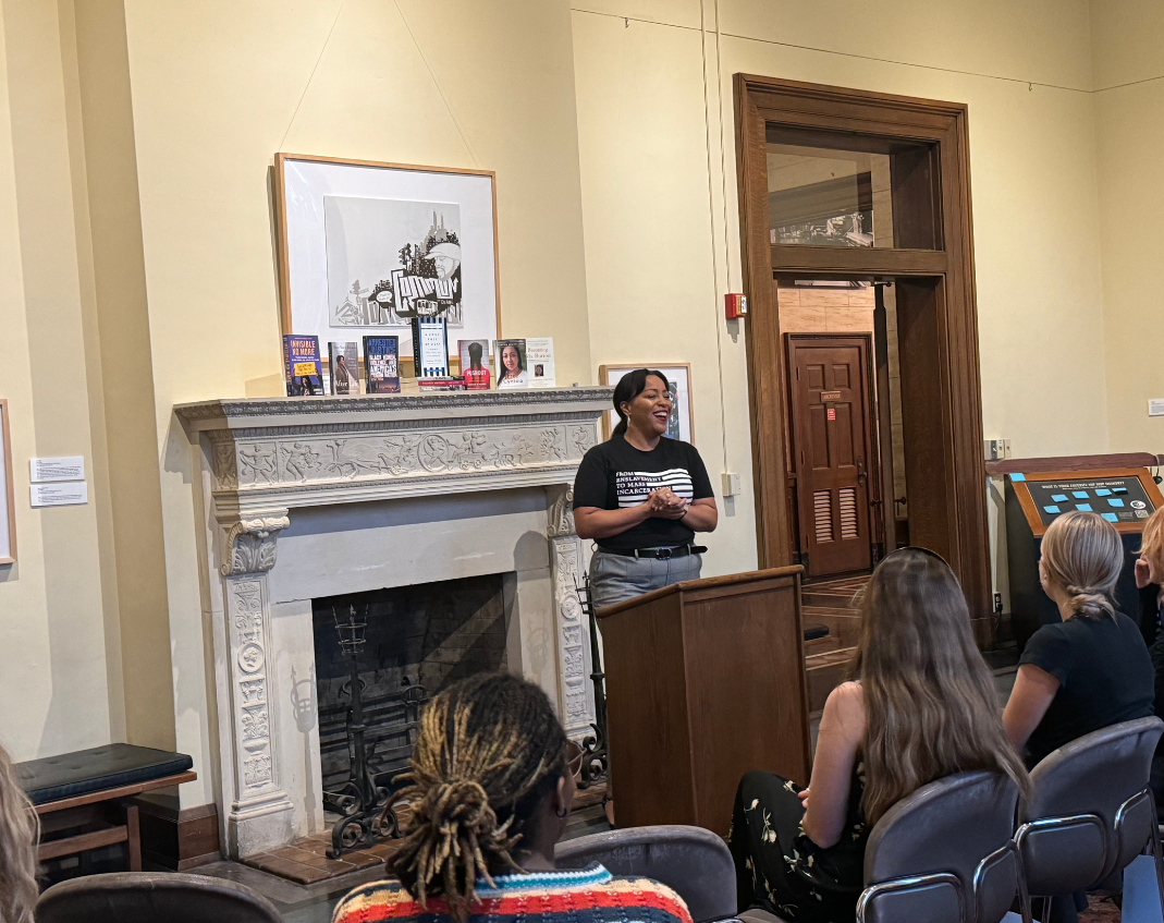 Cynthia speaks in front of a room of people