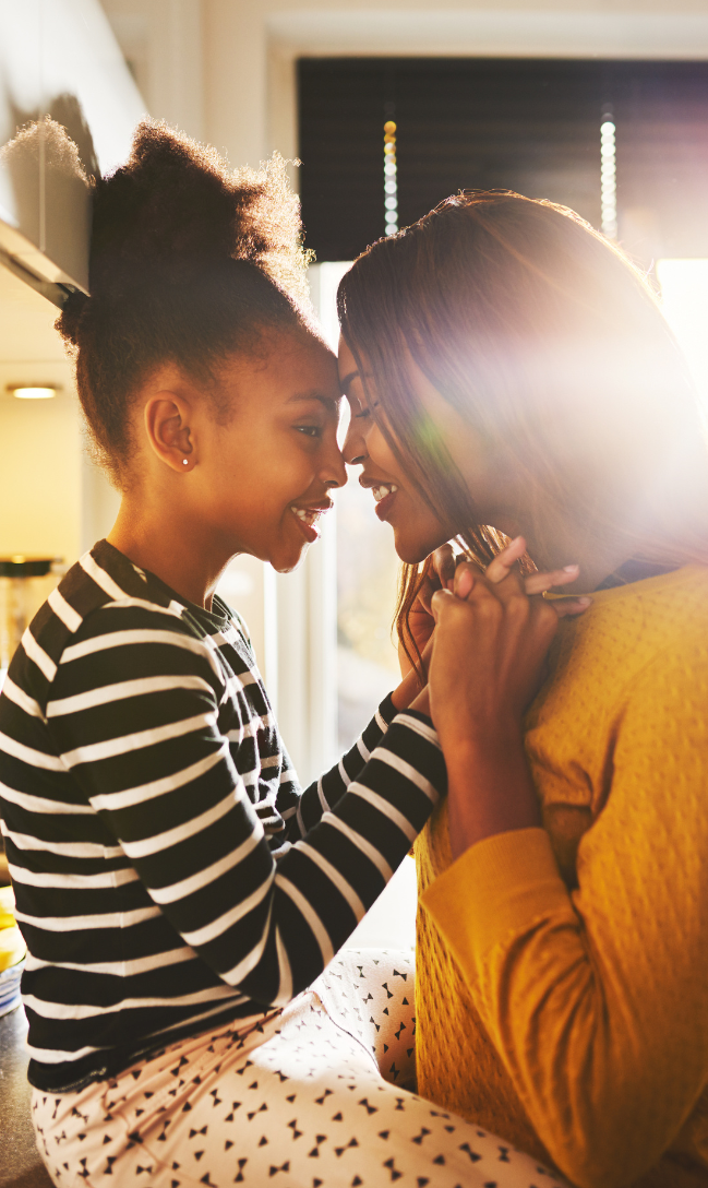 Mother and daughter putting their foreheads together